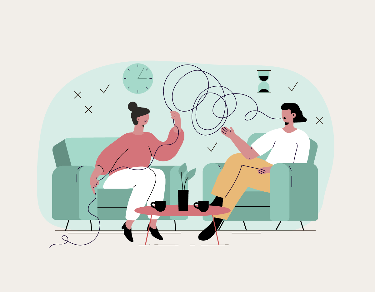 A man and a woman are sitting on a couch talking to each other.
