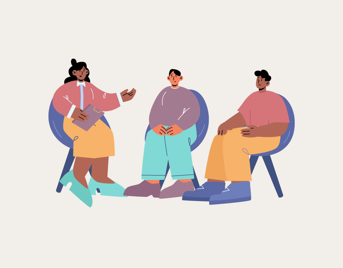 A group of people are sitting in chairs and talking to each other.