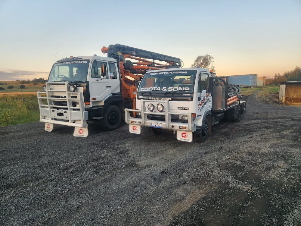 Two White Work Trucks With Front Bull Bars — Coota & Son's Concrete Pumping In South Gundurimba, NSW