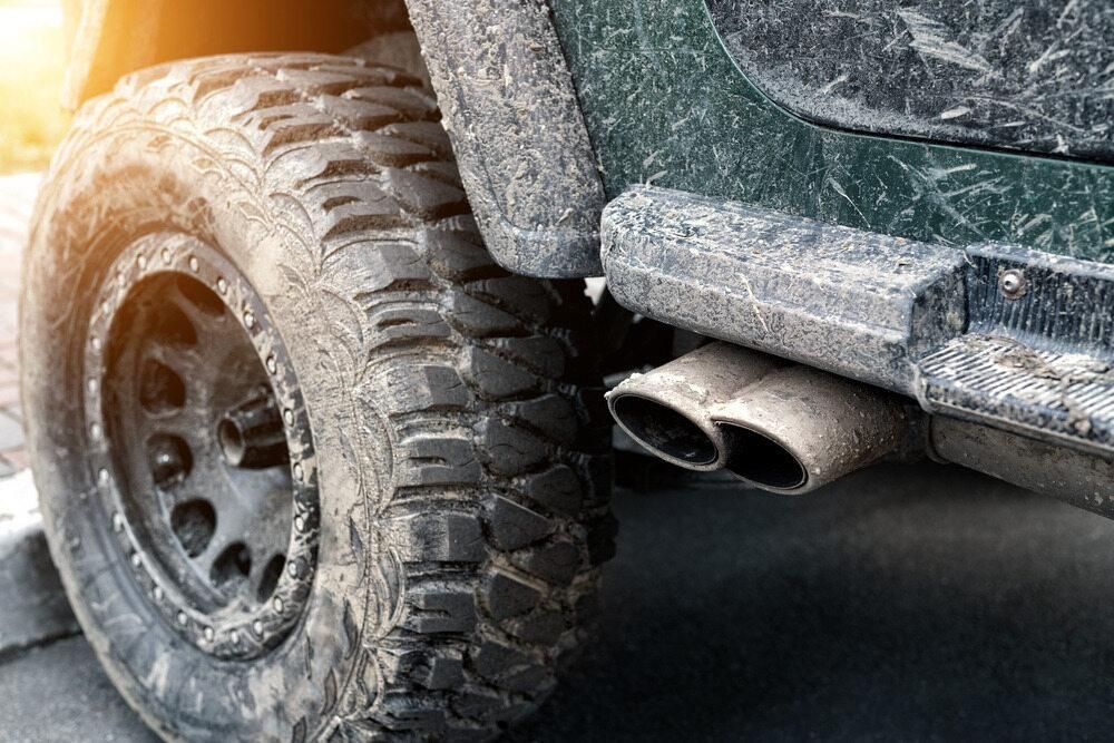 A Close Up Of A Muddy Jeep With A Exhaust Pipe — JBS Mobile In Richmond Hill, NSW