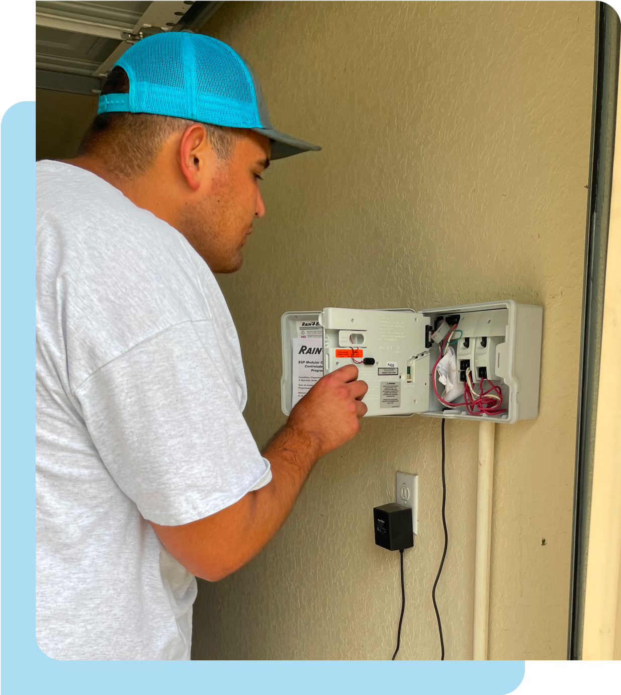 A man working on a water sprinkler console.