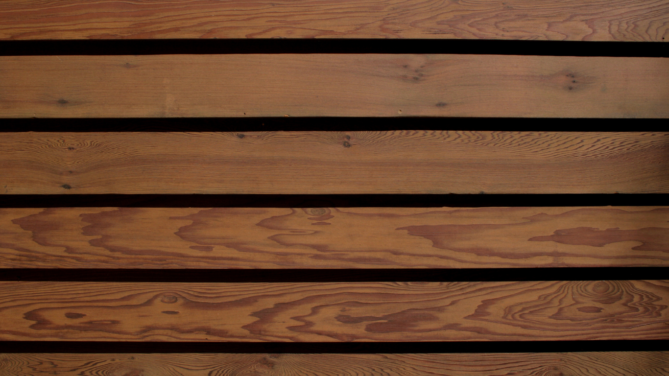 Wooden planks, horizontal, stained brown with dark gaps between.