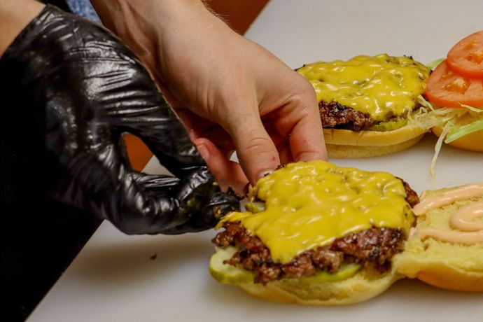 Closeup shot of Outpost Burger bacon hamburger