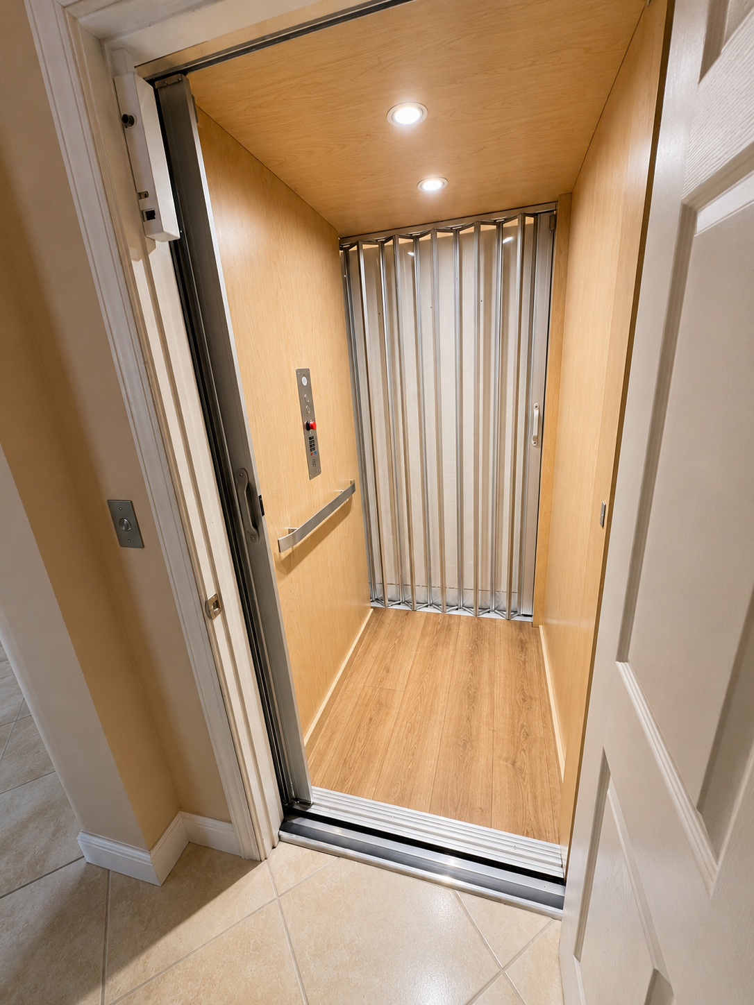 Small wood-paneled elevator with closed striped curtain inside, viewed from a hallway.