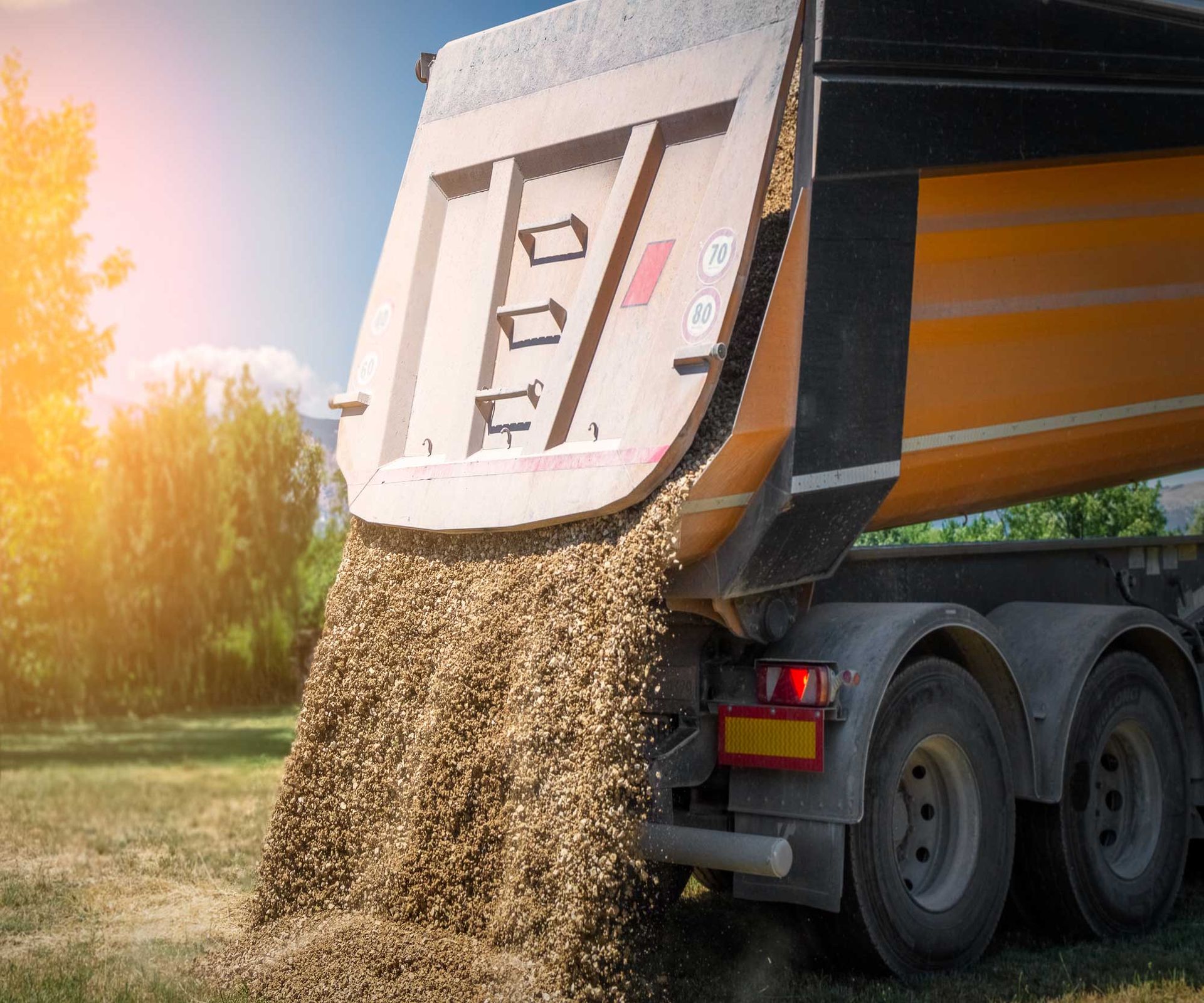 Earthmoving truck delivering quality soil for landscaping. Earthmoving truck delivering quality soil for landscaping.