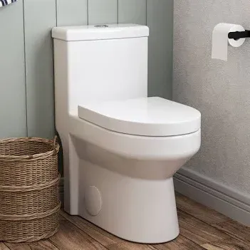 White modern toilet in a bathroom with wood flooring and a wicker basket nearby.