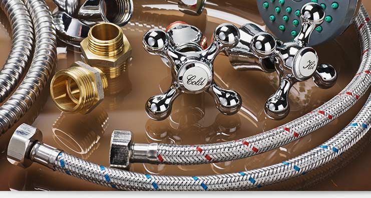 Chrome faucet and braided hoses with brass fittings on a brown surface