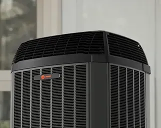 Close-up of a black air conditioner unit with vented grille 