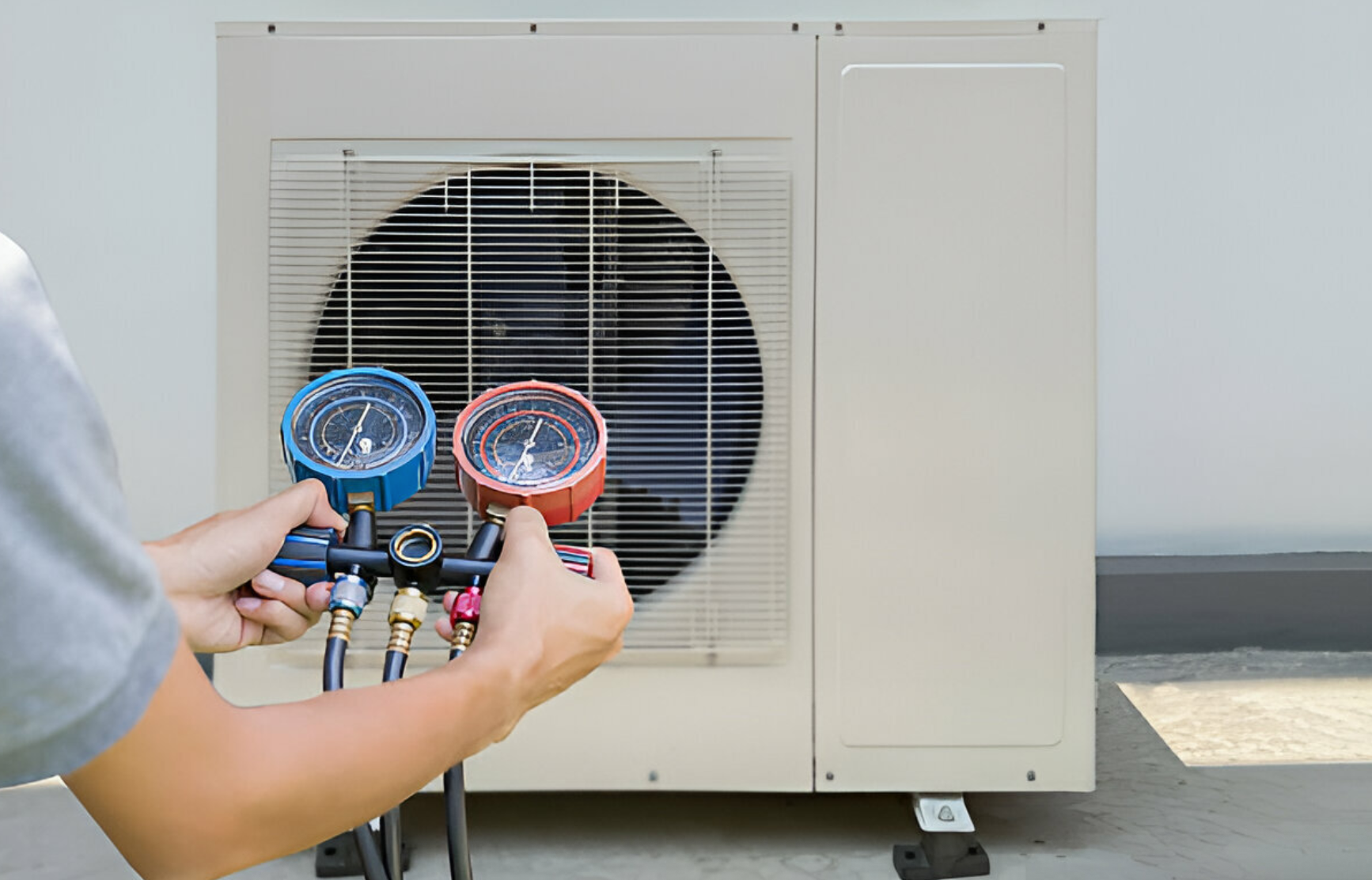 Technician checking air conditioner with manifold gauges outdoors