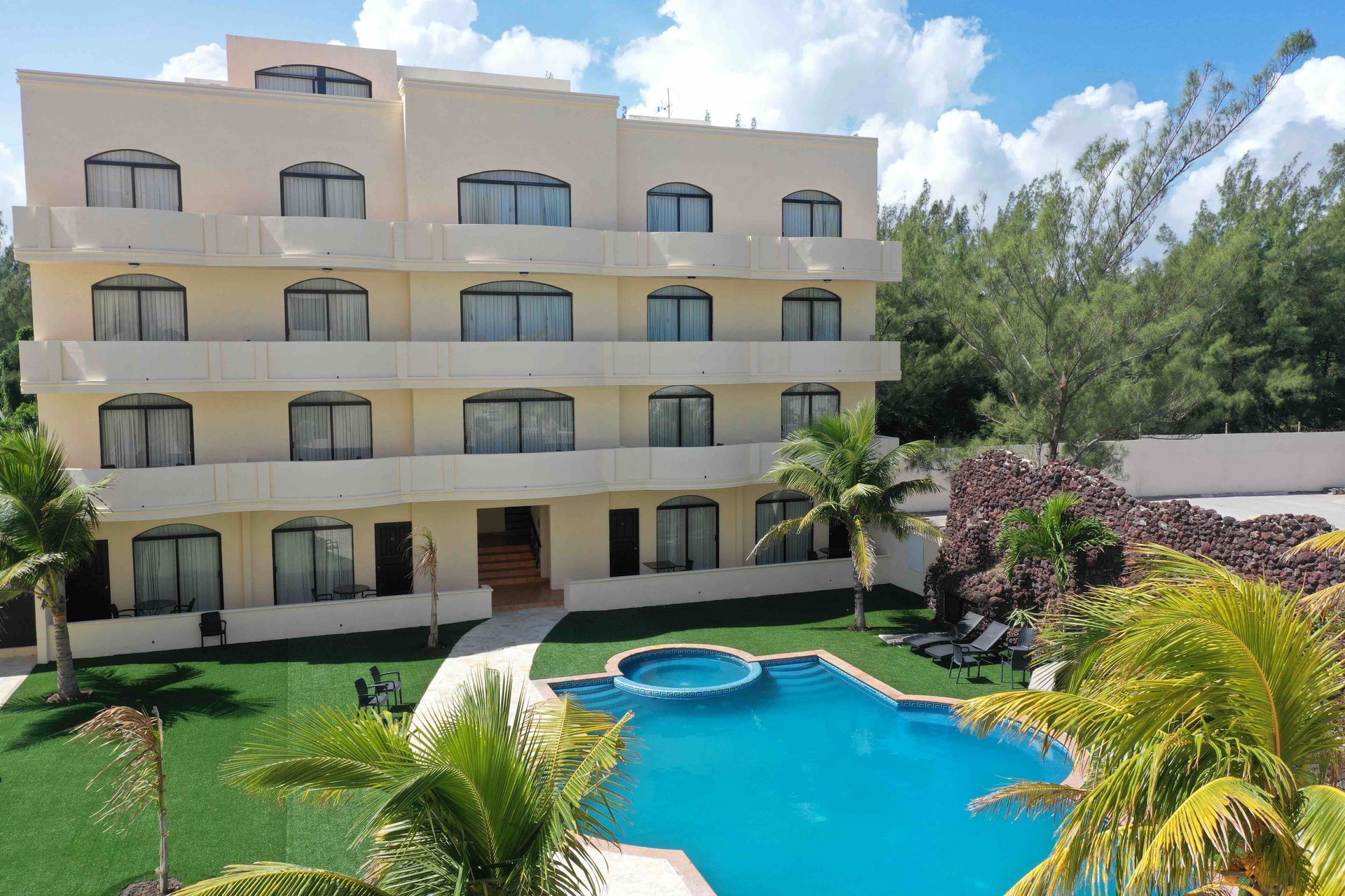 A large building with a swimming pool in front of it
