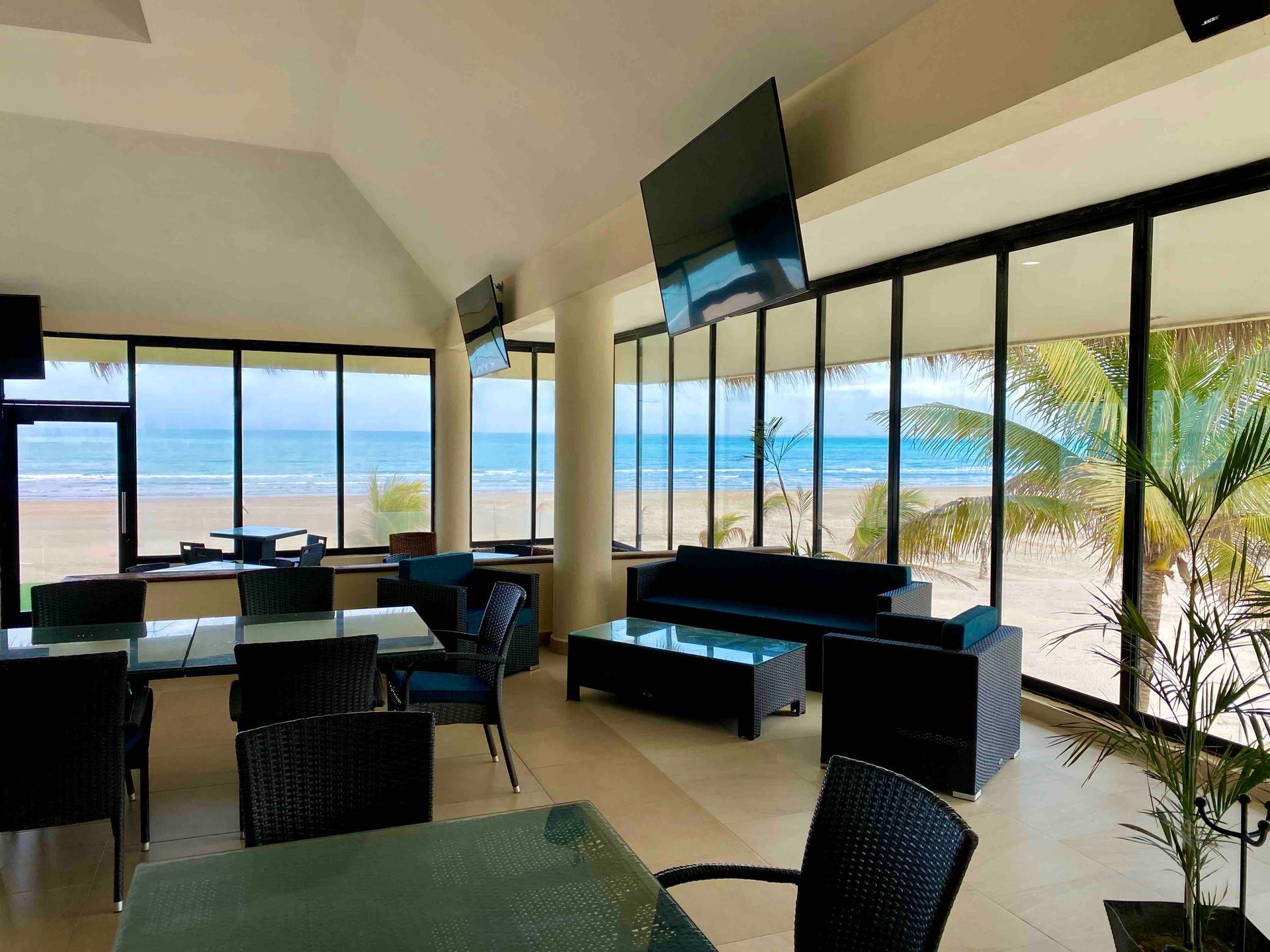 A living room with a couch , chairs , tables and a television.