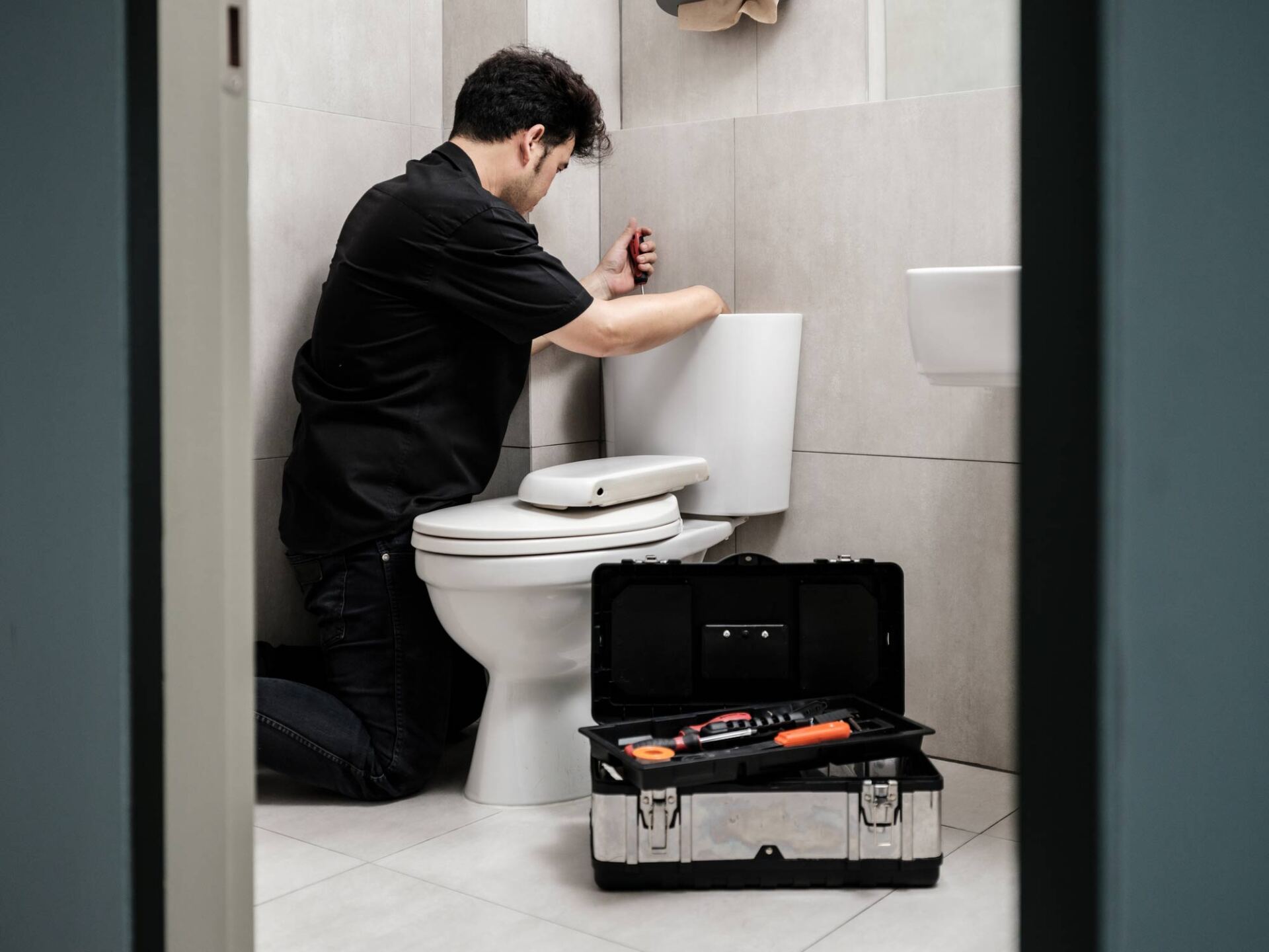 Plumber Fixing The Toilet — Fresno, CA — Kim's Plumbing Plumber Fixing The Toilet — Fresno, CA — Kim's Plumbing