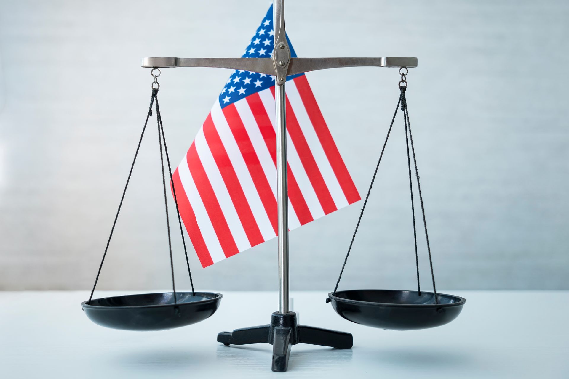 Scales of justice with the American flag in the center.