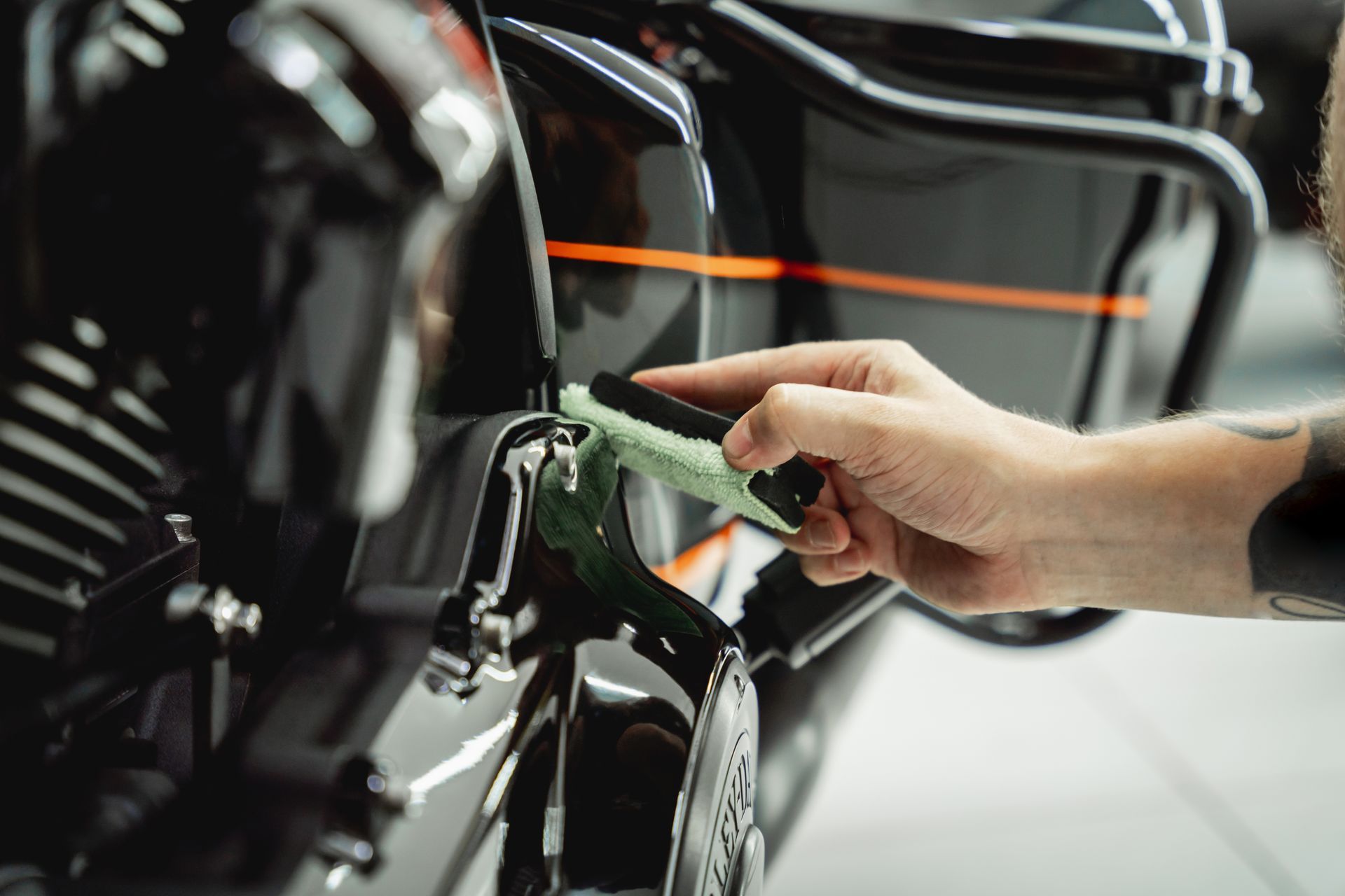 Hand plugging an electric car into a charging port in a garage