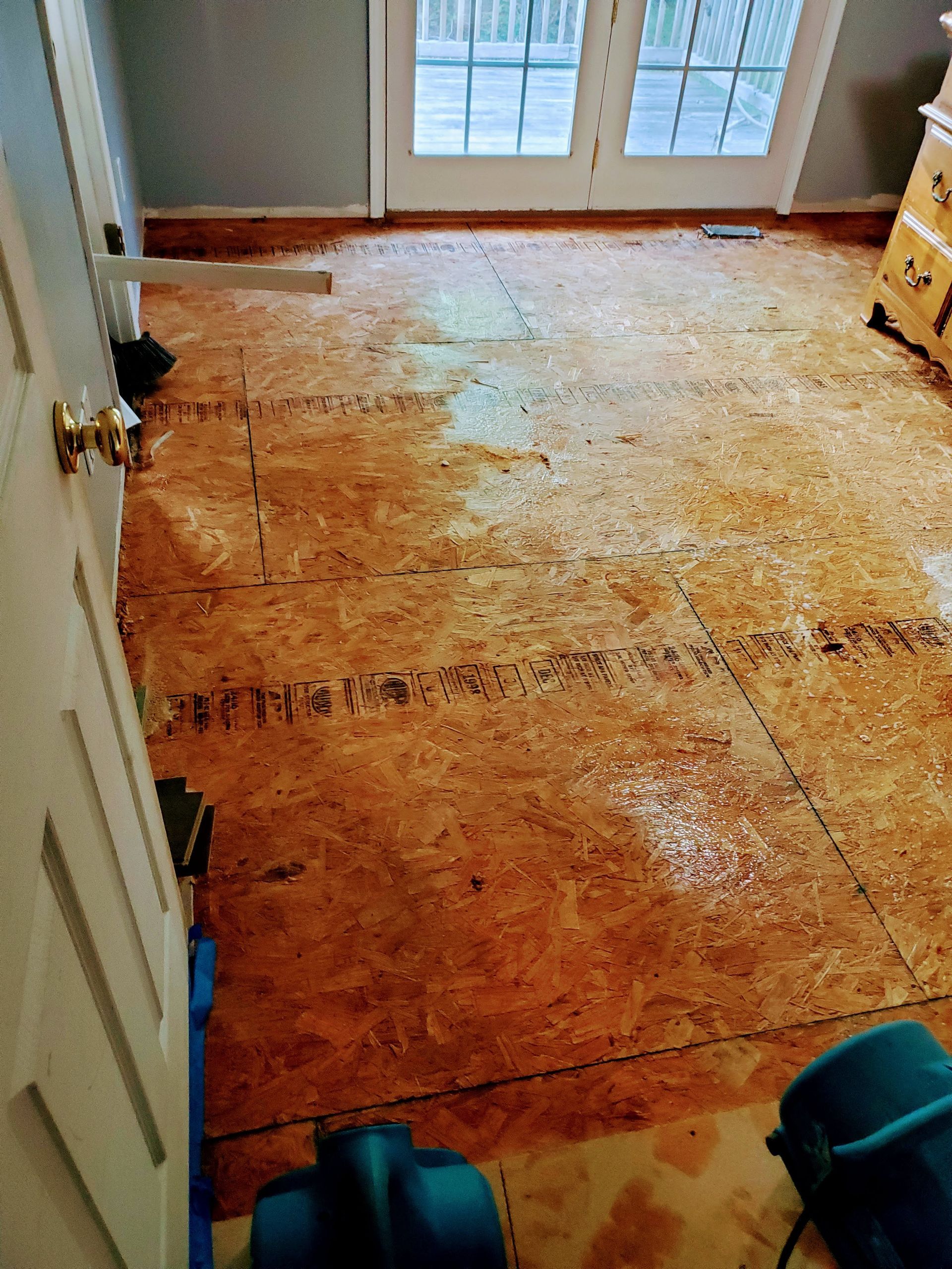 a room with a lot of wooden floors and a door