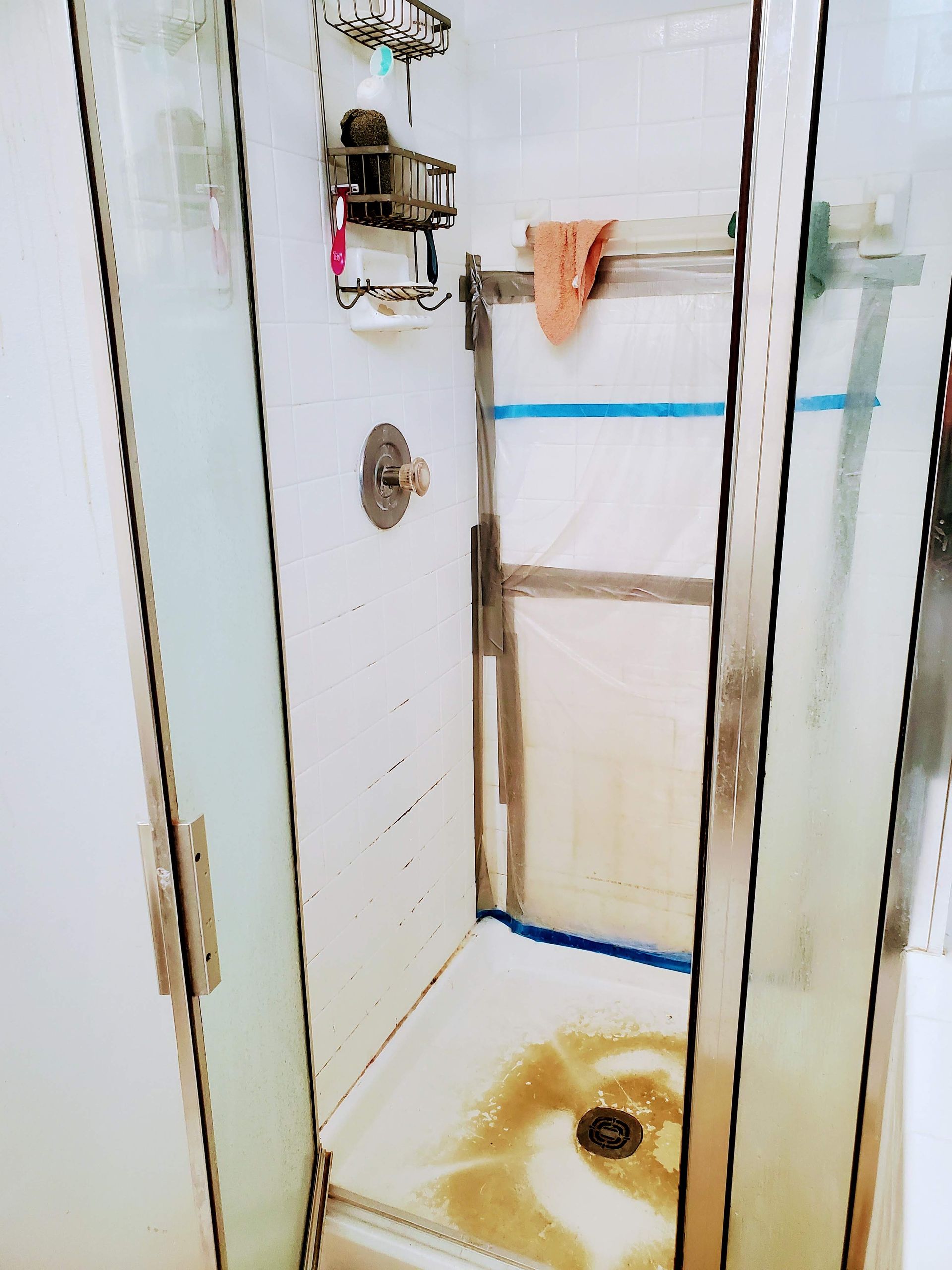 a bathroom with a shower stall and a towel rack