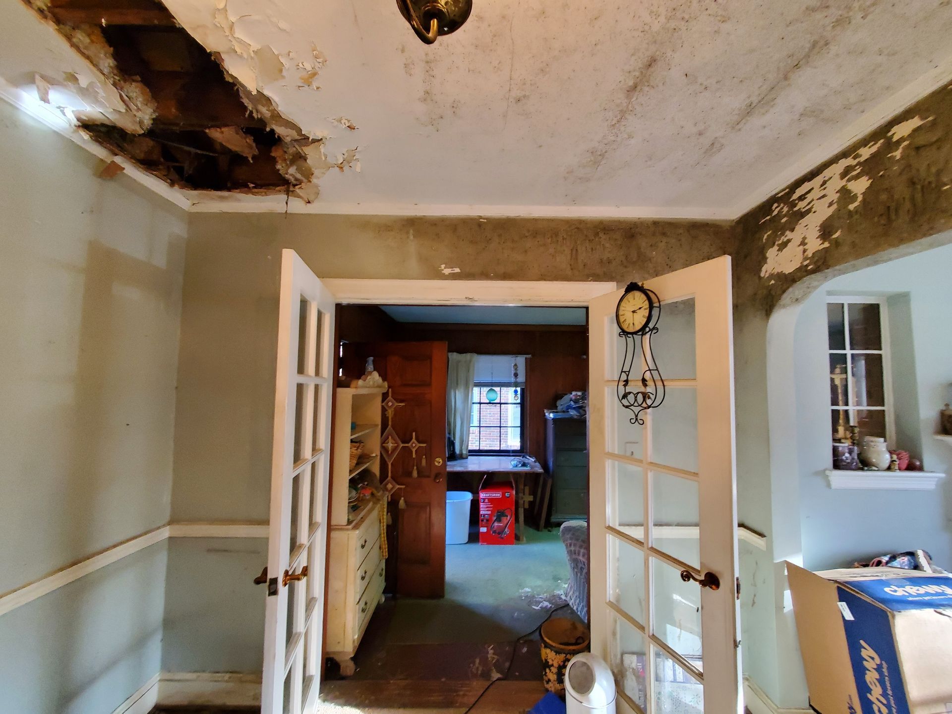 a living room with a clock on the ceiling