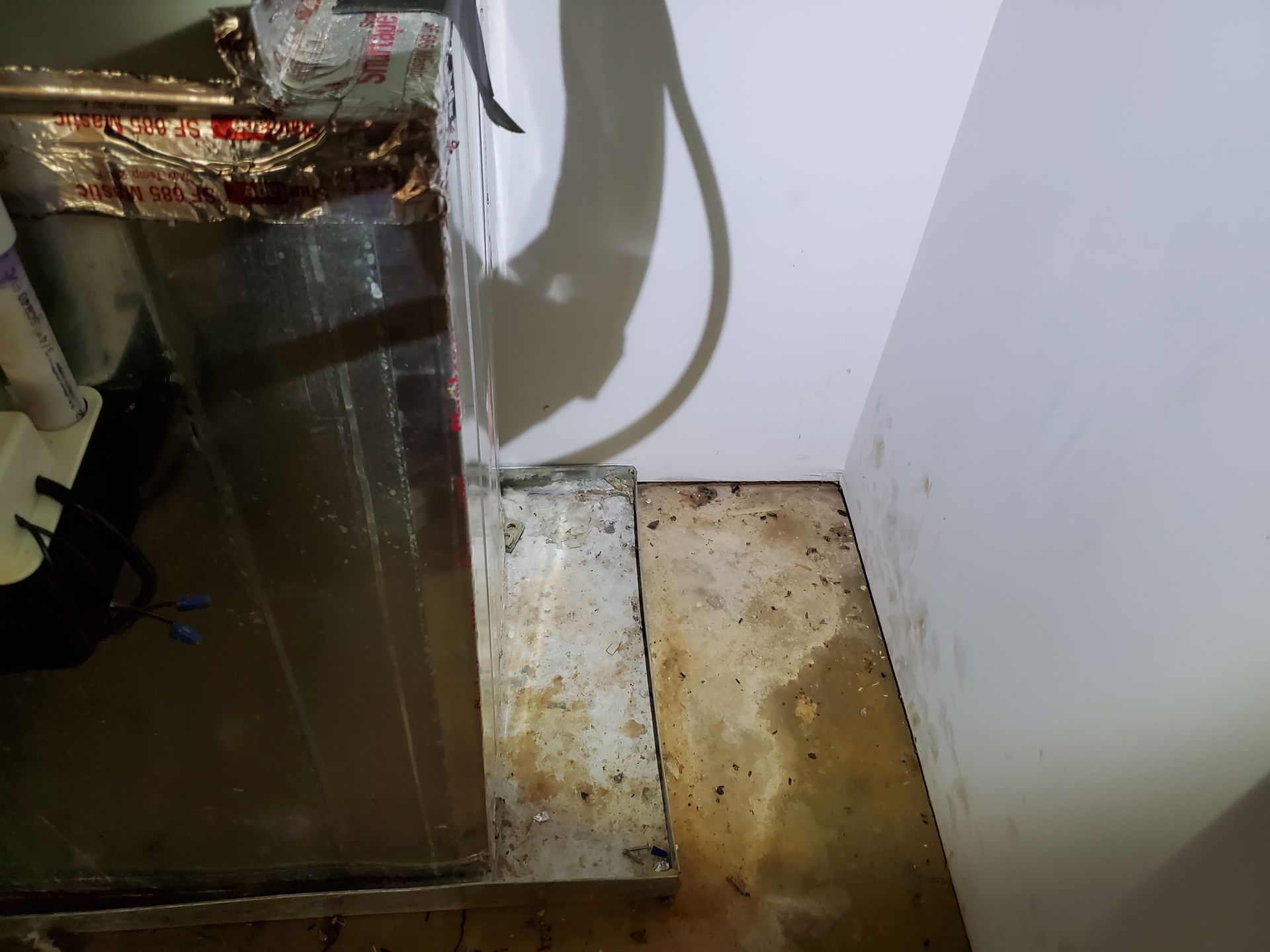 a dirty room with a dirty floor and a dirty wall