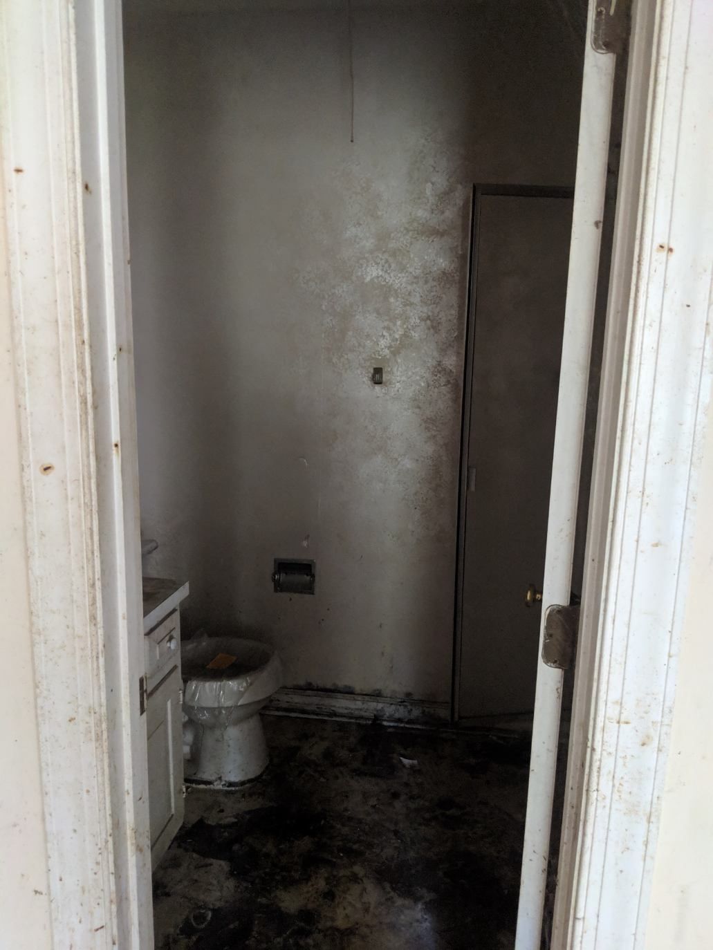 a bathroom with a toilet , sink , and door