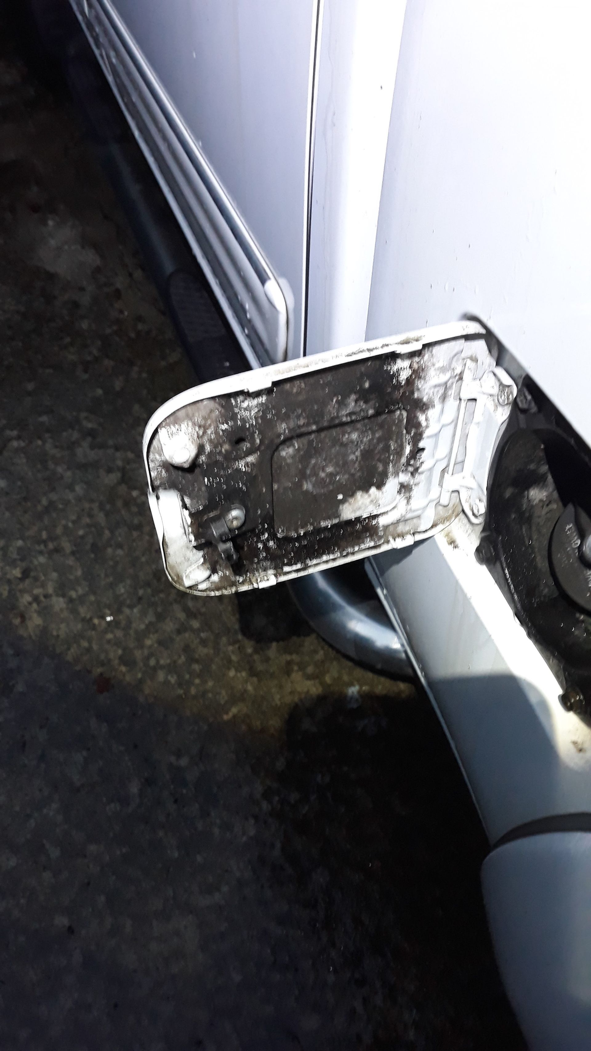 a close up of the side of a car with a broken bumper