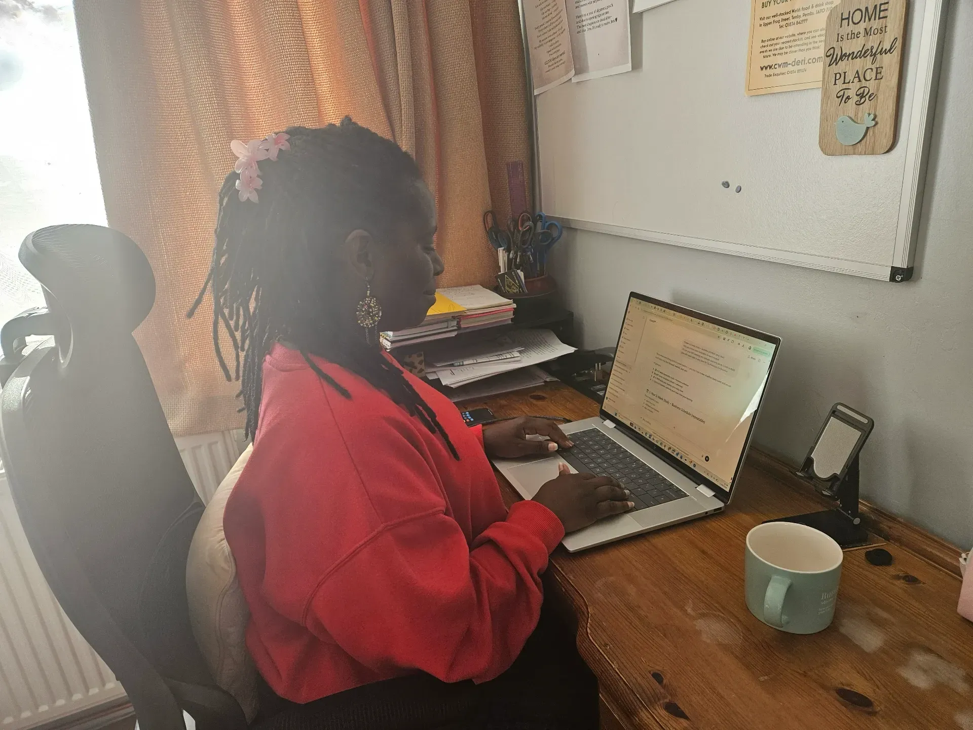 Isamba working at desk as a Virtual Assistant