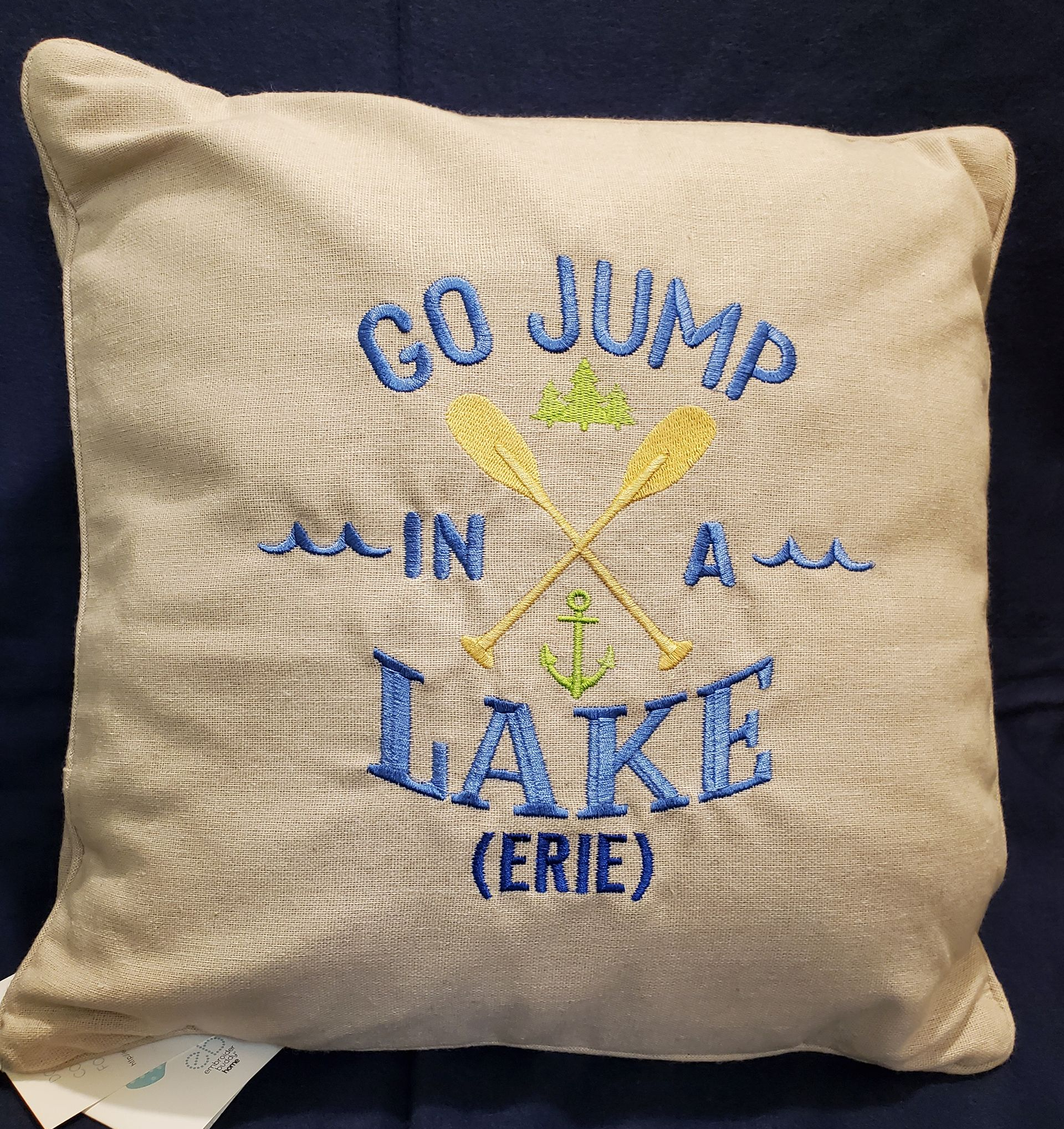 Tan pillow with embroidered