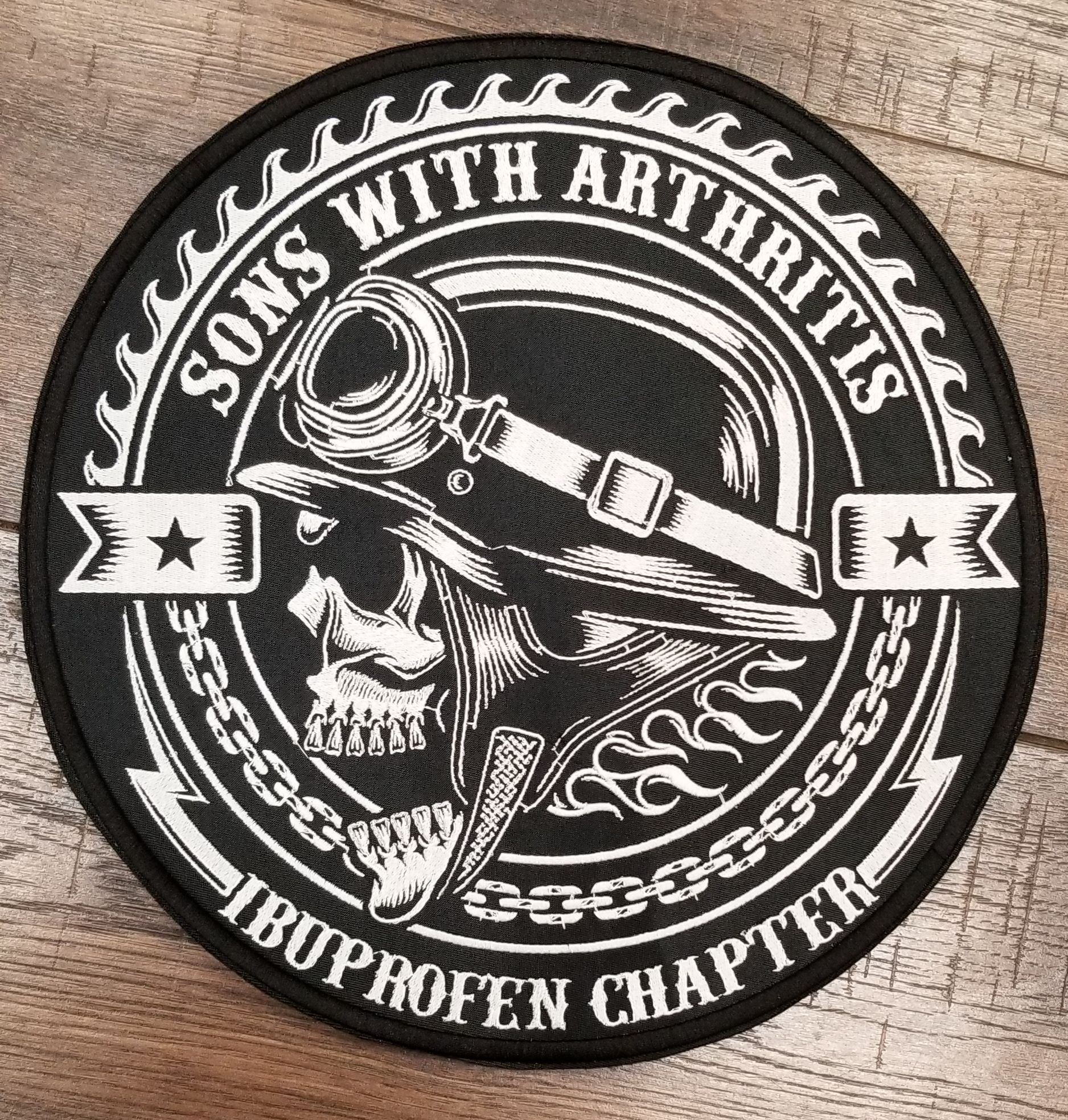 Black and white patch with skull wearing goggles and the words 