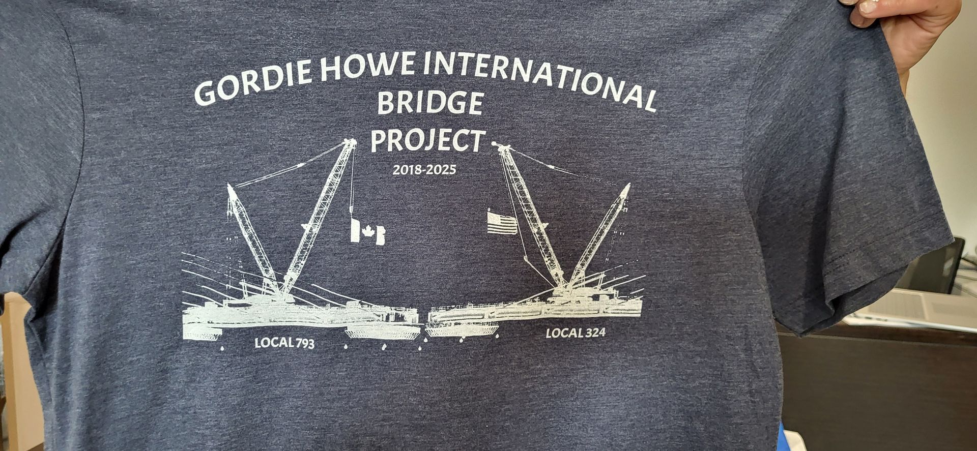 Navy blue t-shirt with a white graphic of a construction crane and the words