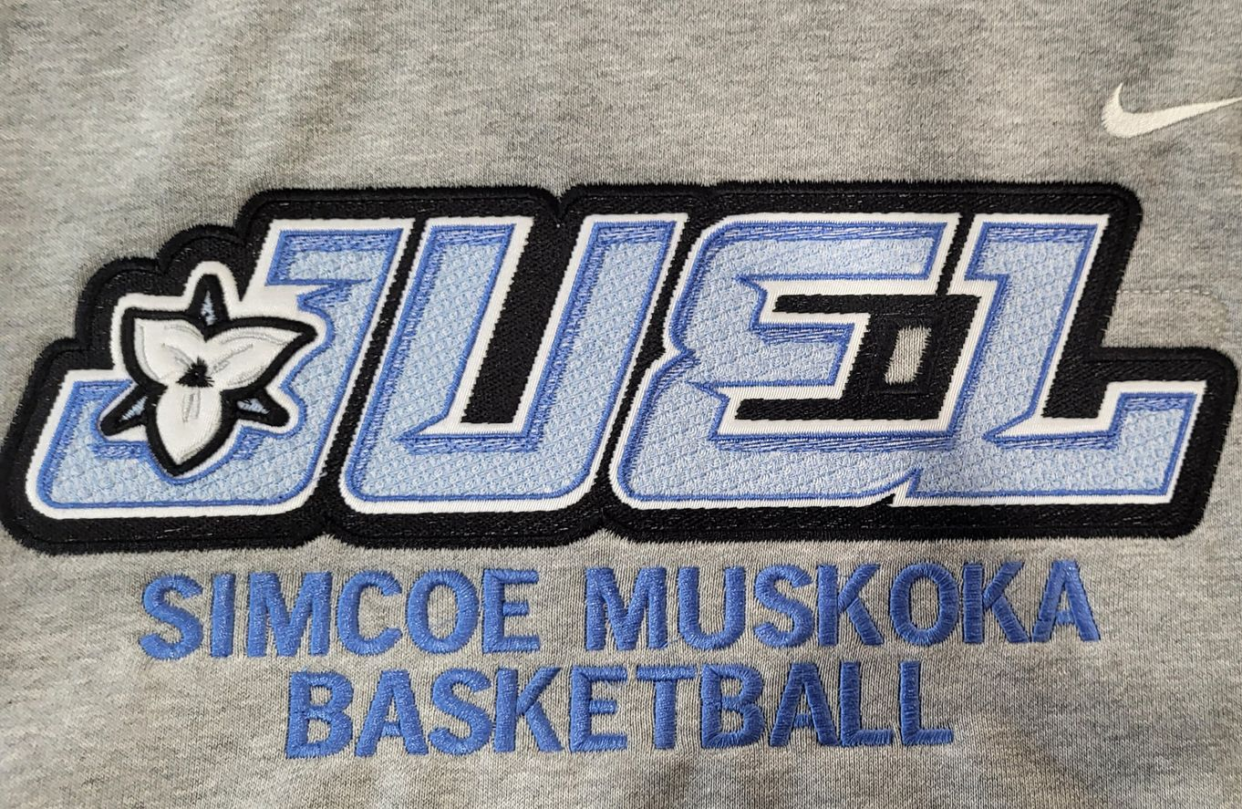 Embroidered logo on gray fabric: