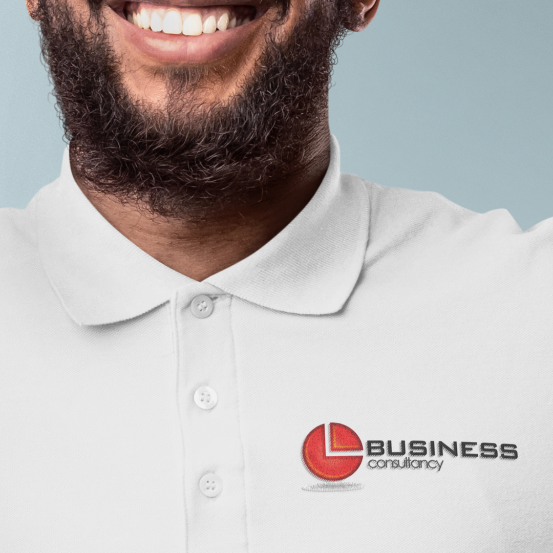 Man smiling, wearing a white polo shirt with