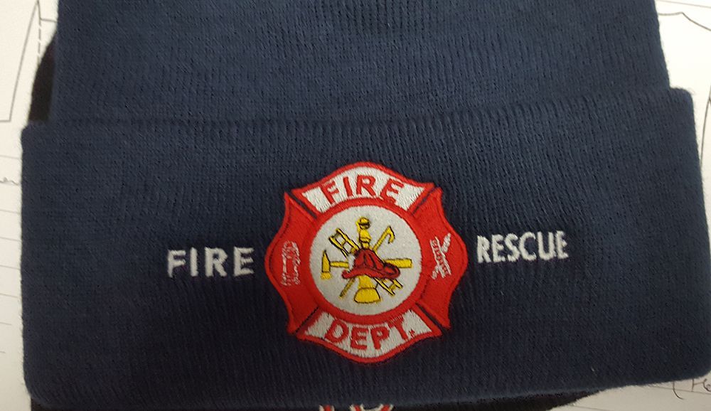 Navy blue firefighter beanie with a red and white fire dept. emblem.