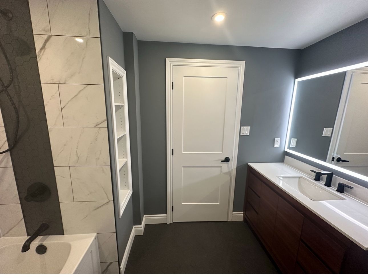 A bathroom with two sinks and a mirror