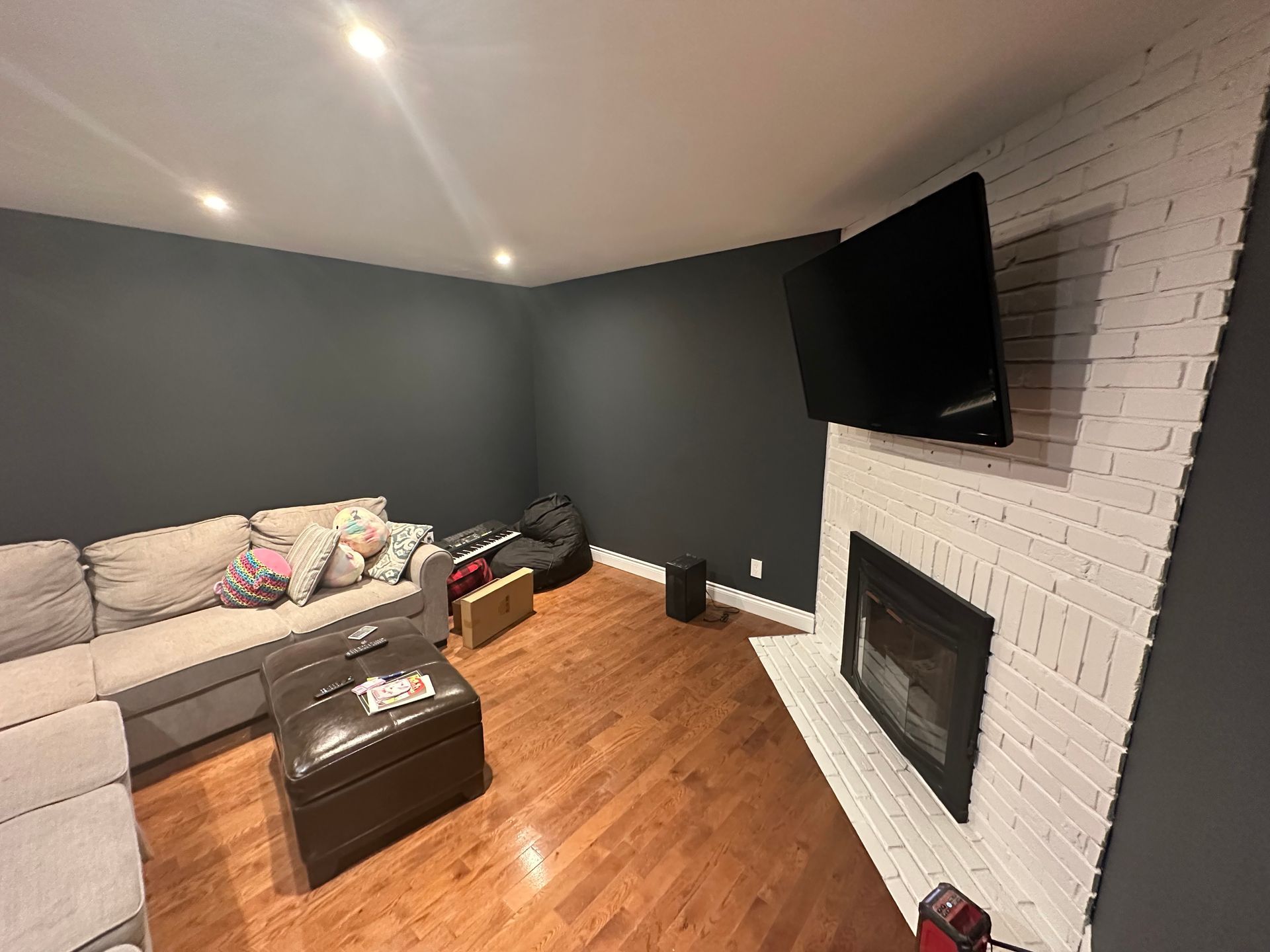 A living room with a fireplace , couch , and television.