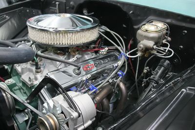 A close up of a car engine with a air filter