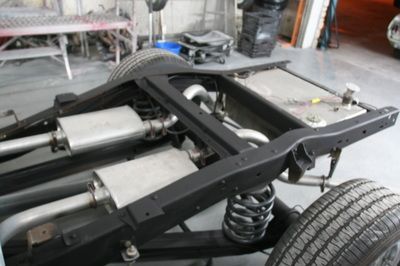 The chassis of a car is being built in a garage
