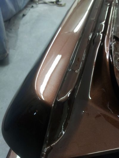 A close up of the hood of a brown car