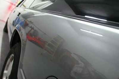A close up of a car 's side in a garage