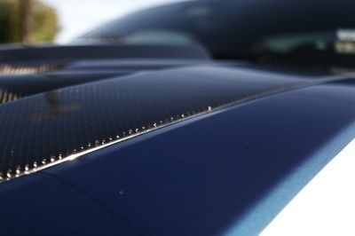 A close up of the hood of a blue car