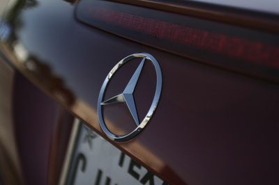 A close up of a mercedes emblem on the back of a car