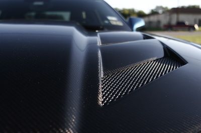 A close up of the hood of a black car