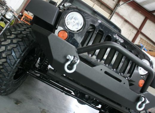A black jeep with hooks on the front bumper