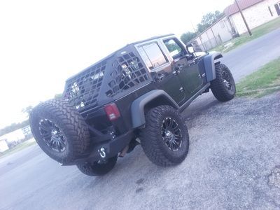 A black jeep is parked on the side of the road