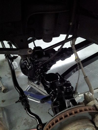 A close up of the underside of a car with a brake disc
