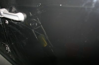 A close up of a door handle in a dark room