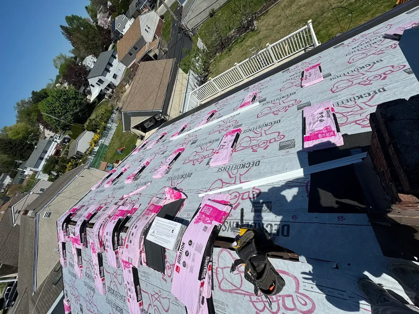 Rooftop covered in pink and white protest signs with handwritten messages, viewed at an angle.