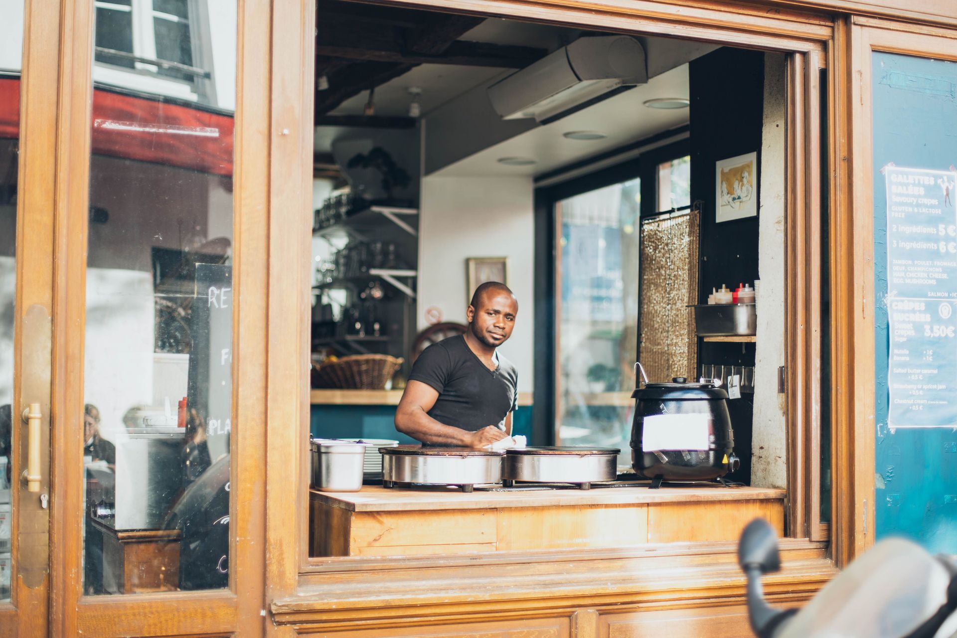Business owner in the real café environment, no laptop