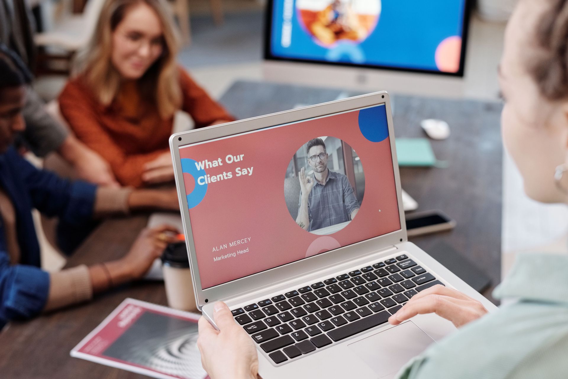Person holding a laptop in a meeting room, showing customer reviews, that builds trust.