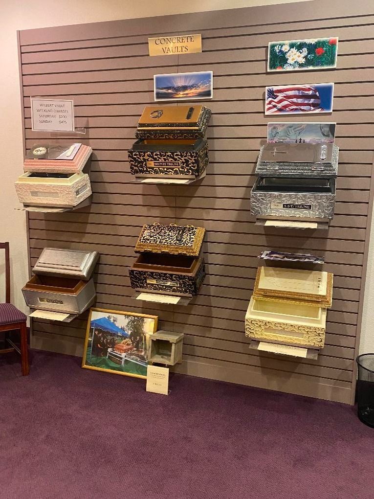 Wall display of colorful greeting cards on racks against a tan slatwall in a shop.