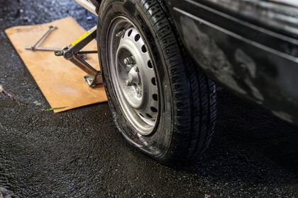A man wearing white gloves is working on a brake disc.