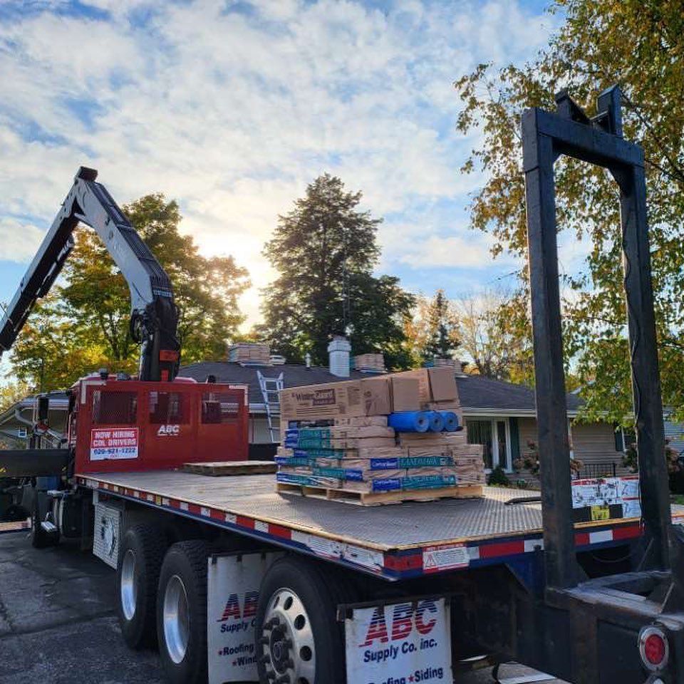 A truck with a crane on the back of it that says abc.
